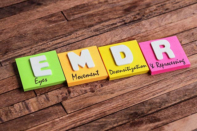 Letters on a table showing what EMDR Therapy stands for - Eyes, Movement, Desensitization, and Reprocessing.