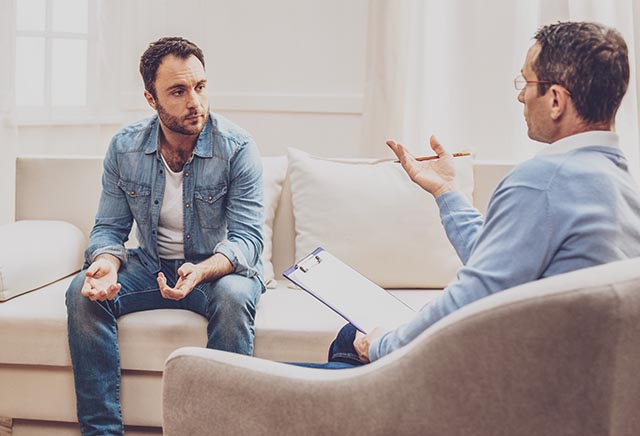 Individual, private therapy session between a client and his therapist, receiving help for mental health and addiction.