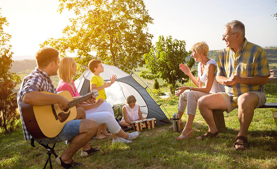 An addict and his family enjoying time camping together.