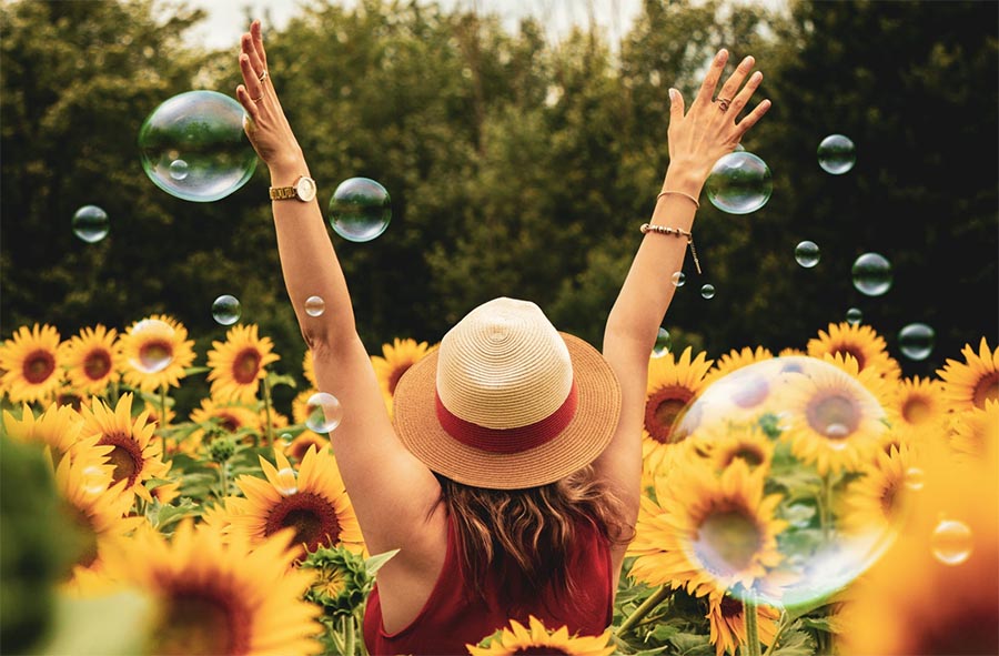 Excercise has a positive impact on mood - happy woman in field