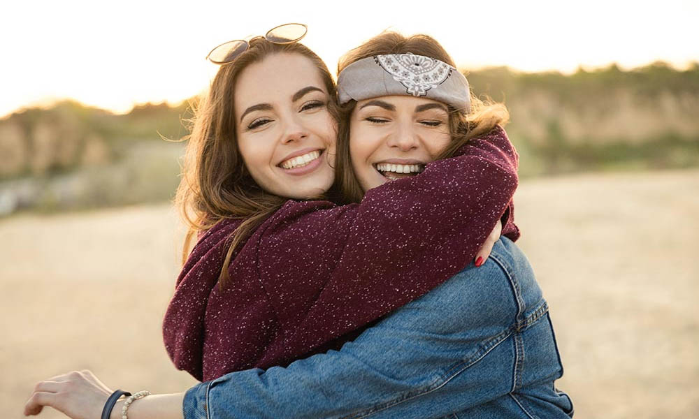 A young lady who is sober hugs her twelve step sponsor