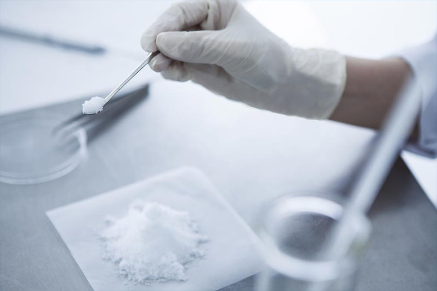 Naloxone being handled in a lab to make Narcan, used for treating opioid overdoses. 