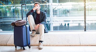 Man at the airport with suitcase headed to out of state rehab