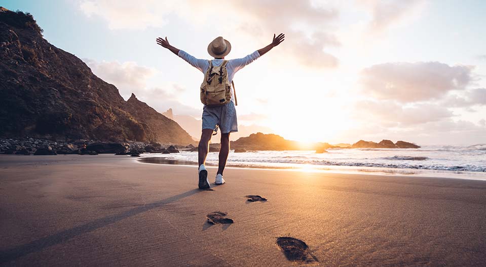 A man walks along the beach in near our California rehab after getting treatment for addiction and his addictive personality.