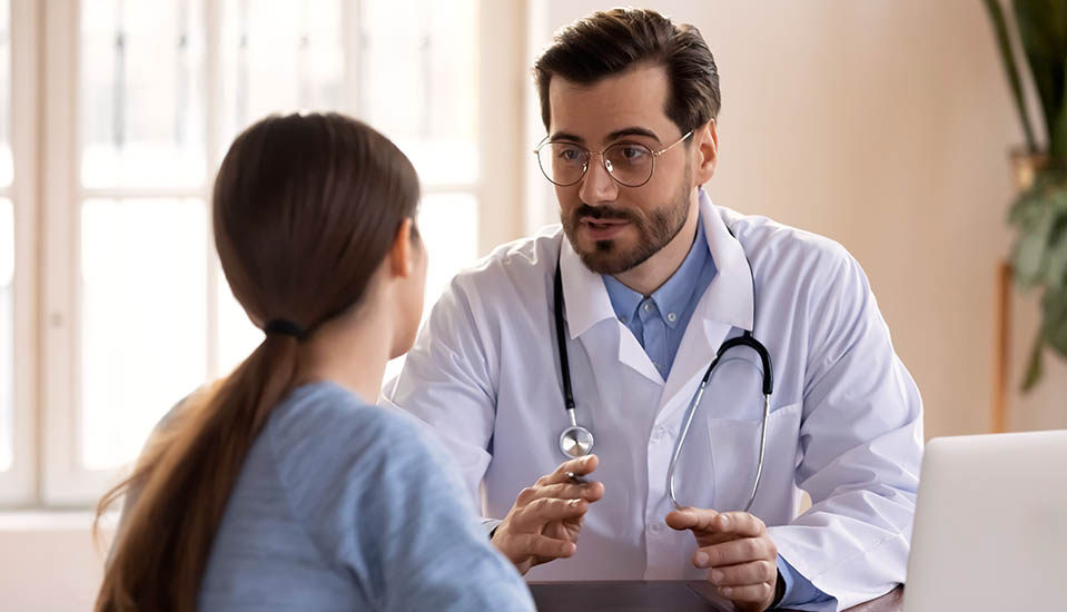 A woman speaks with a Medical Doctor at a treatment facility to receive an accurate diagnosis and proper treatment for her co-occurring disorders.