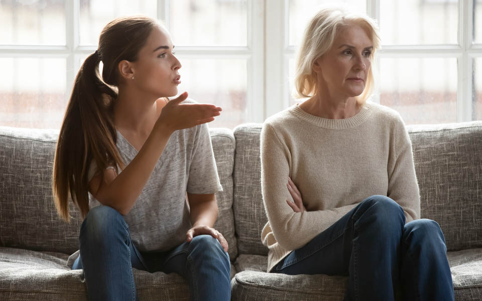 A young woman addicted to drugs sits next to and berates her codependant mother.