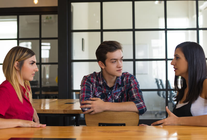 Group of young adults talking to each other about addiction