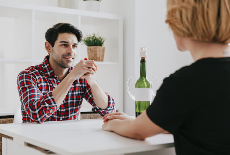 Man talking to woman about their alcoholic traits