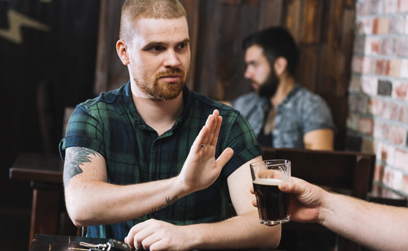 Man refusing an offer of alcohol