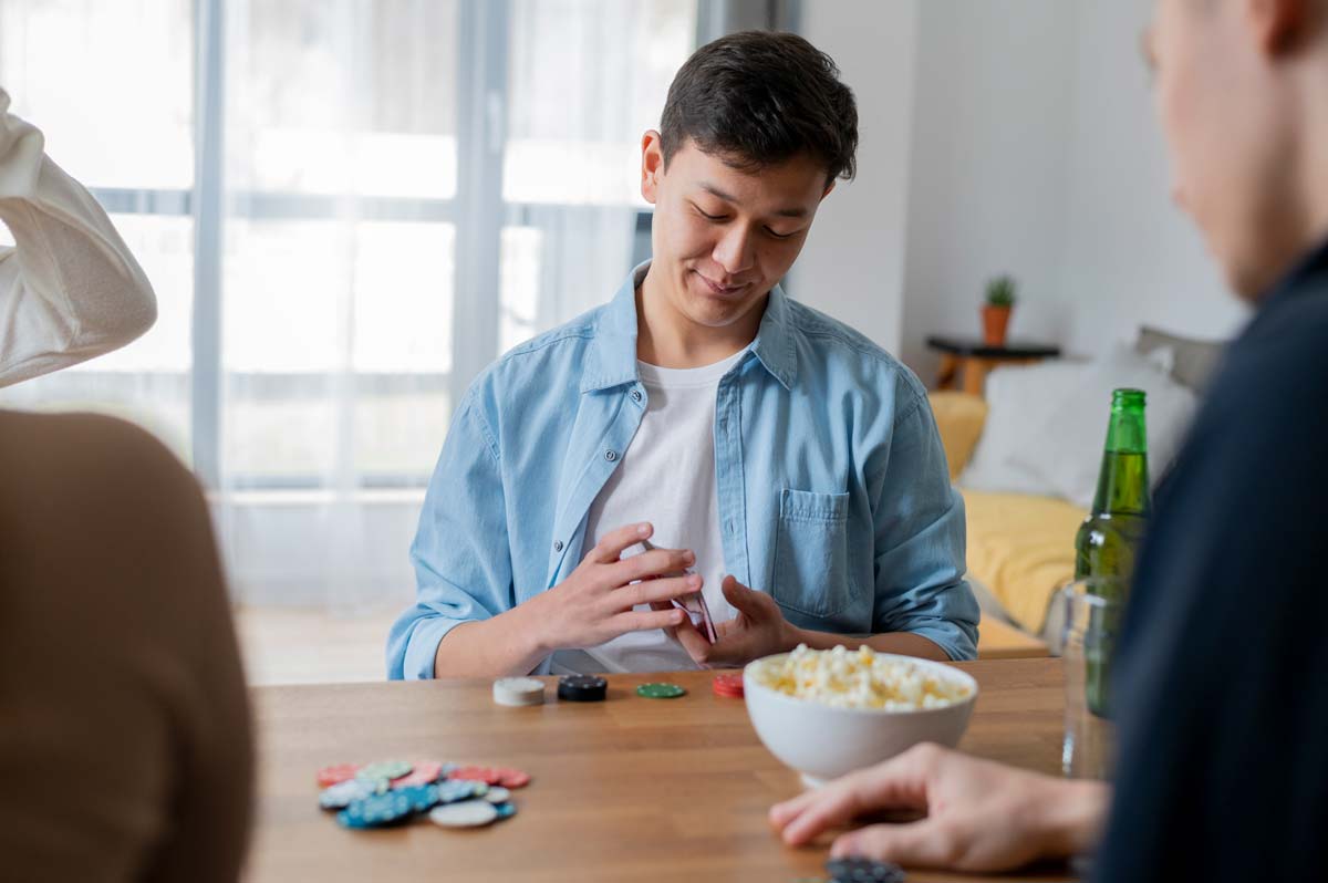 Man playing games with his friends smiling to himself