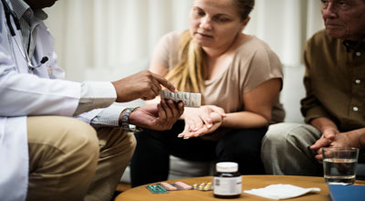 Doctor talking to older couple about their prescription medication