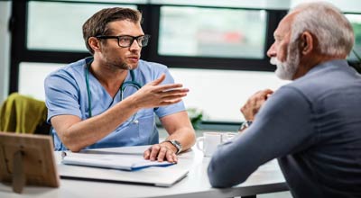 man talking to a doctor about their new addiction treatment