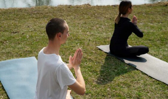 woman and man doing yoga outside to help combat their substance abuse addiction