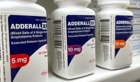 Bottles of Adderall XR 5mg, 10mg, and 15mg prescription medication, representing Adderall addiction versus dependence and the risks of misuse.