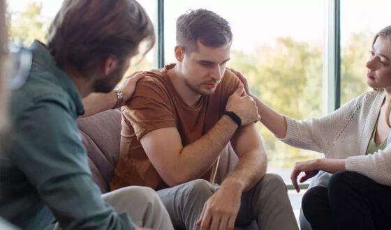 Young man receiving support during group therapy session, highlighting holistic approaches to mental health treatment at 12 South Recovery in Lake Forest, California.