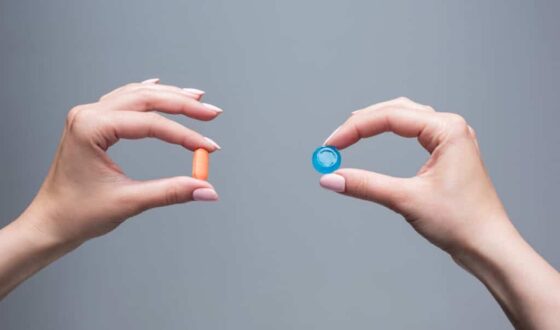 Hands holding two different pills, symbolizing the comparison between Buspirone and Xanax for anxiety treatment — discussed by 12 South Recovery in Orange County, CA.