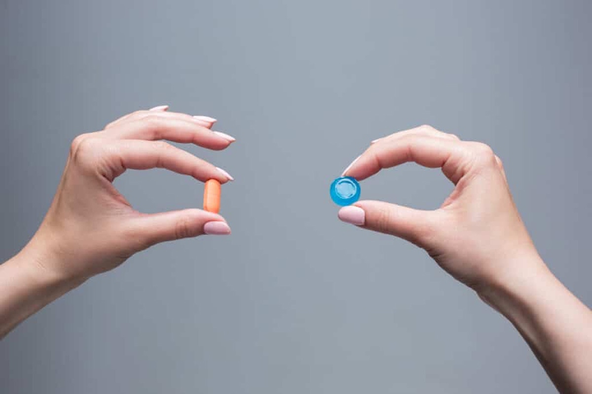 Hands holding two different pills, symbolizing the comparison between Buspirone and Xanax for anxiety treatment — discussed by 12 South Recovery in Orange County, CA.