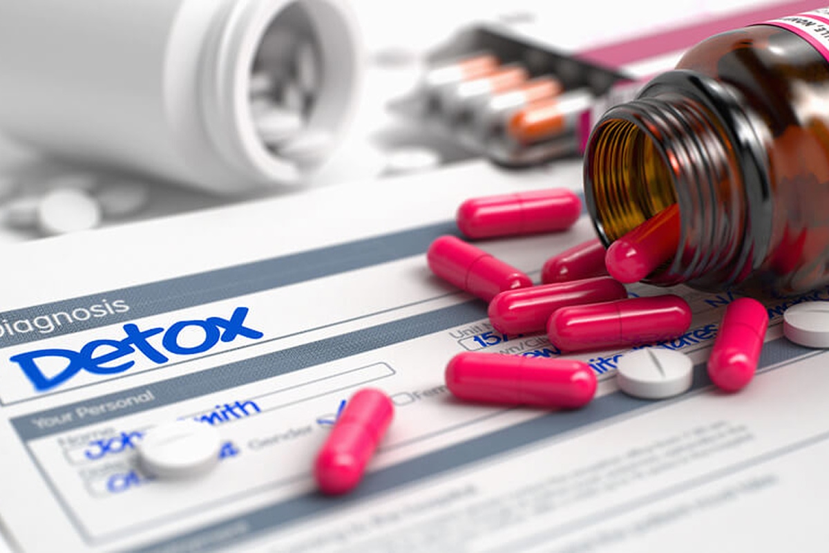Close-up of spilled medication capsules on a detox form, symbolizing medical detox and treatment for mixing alcohol and drugs at 12 South Recovery in Orange County, CA.