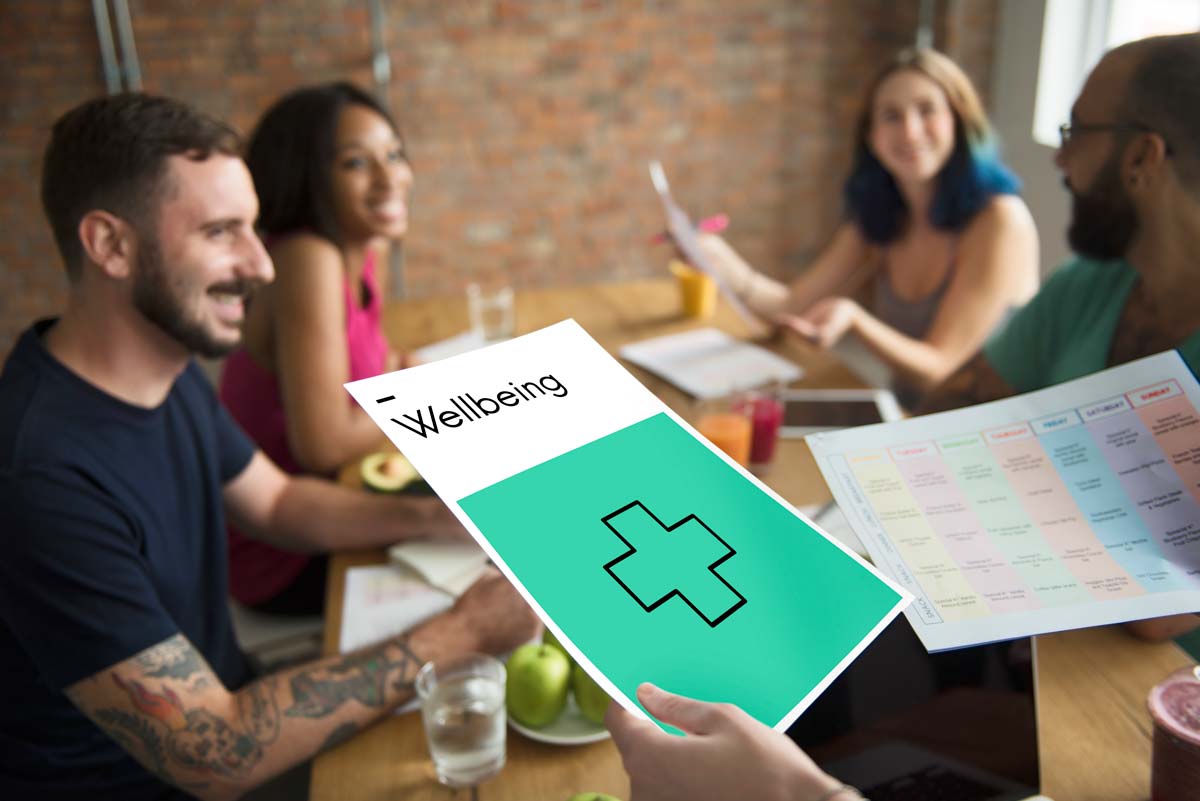 Group discussing wellbeing and recovery plans in a supportive setting, representing community support in Orange County residential treatment and detox programs.