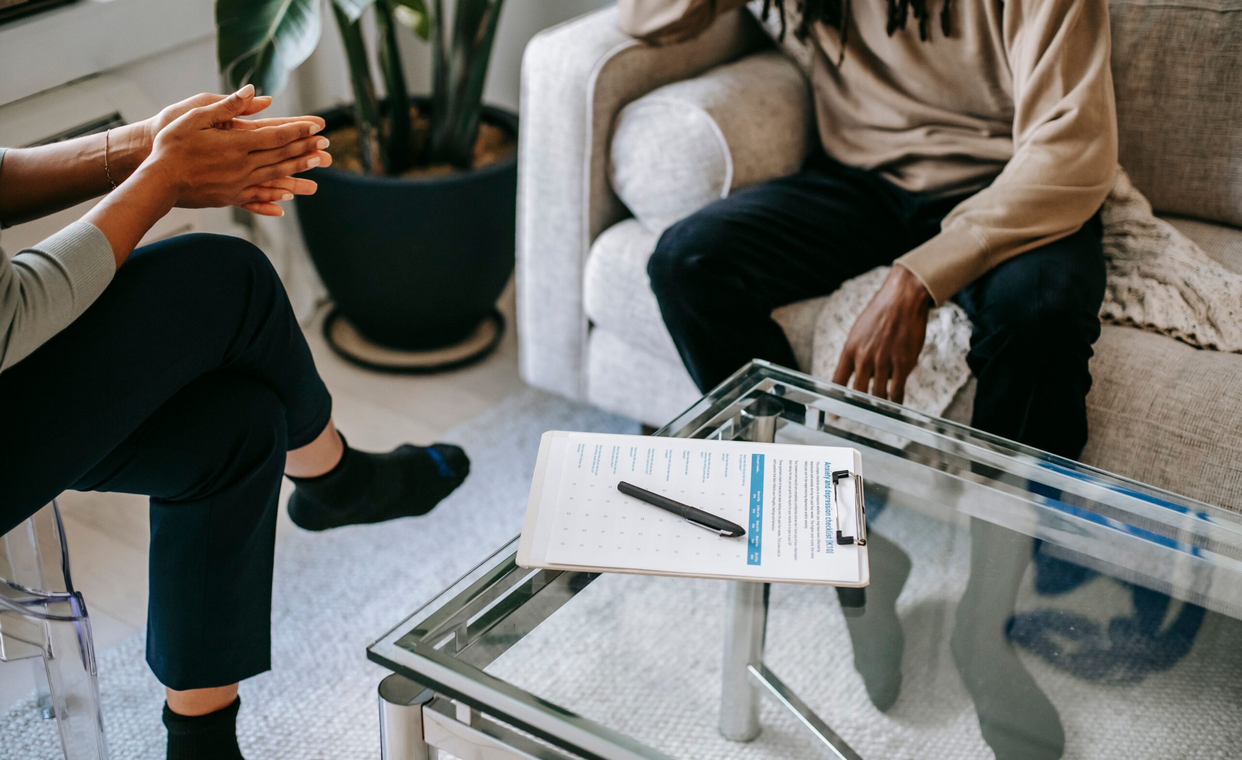 Person participating in an intensive outpatient program (IOP) counseling session with a therapist, discussing recovery goals and treatment progress in a supportive mental health and addiction treatment setting.