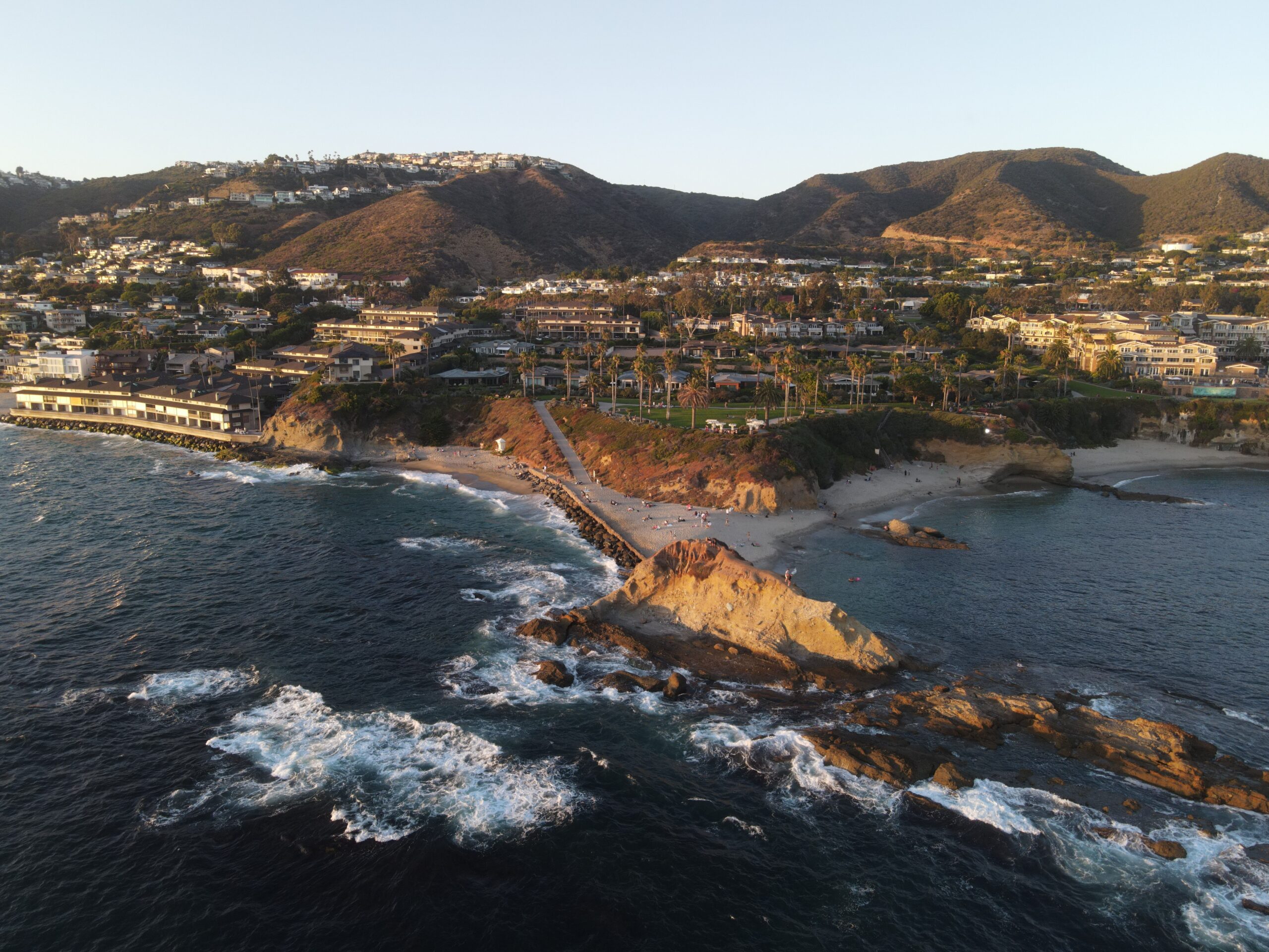 Aerial view of the Orange County coast featuring scenic beaches, coastal cliffs, and a tranquil setting known for health, wellness, and recovery programs.