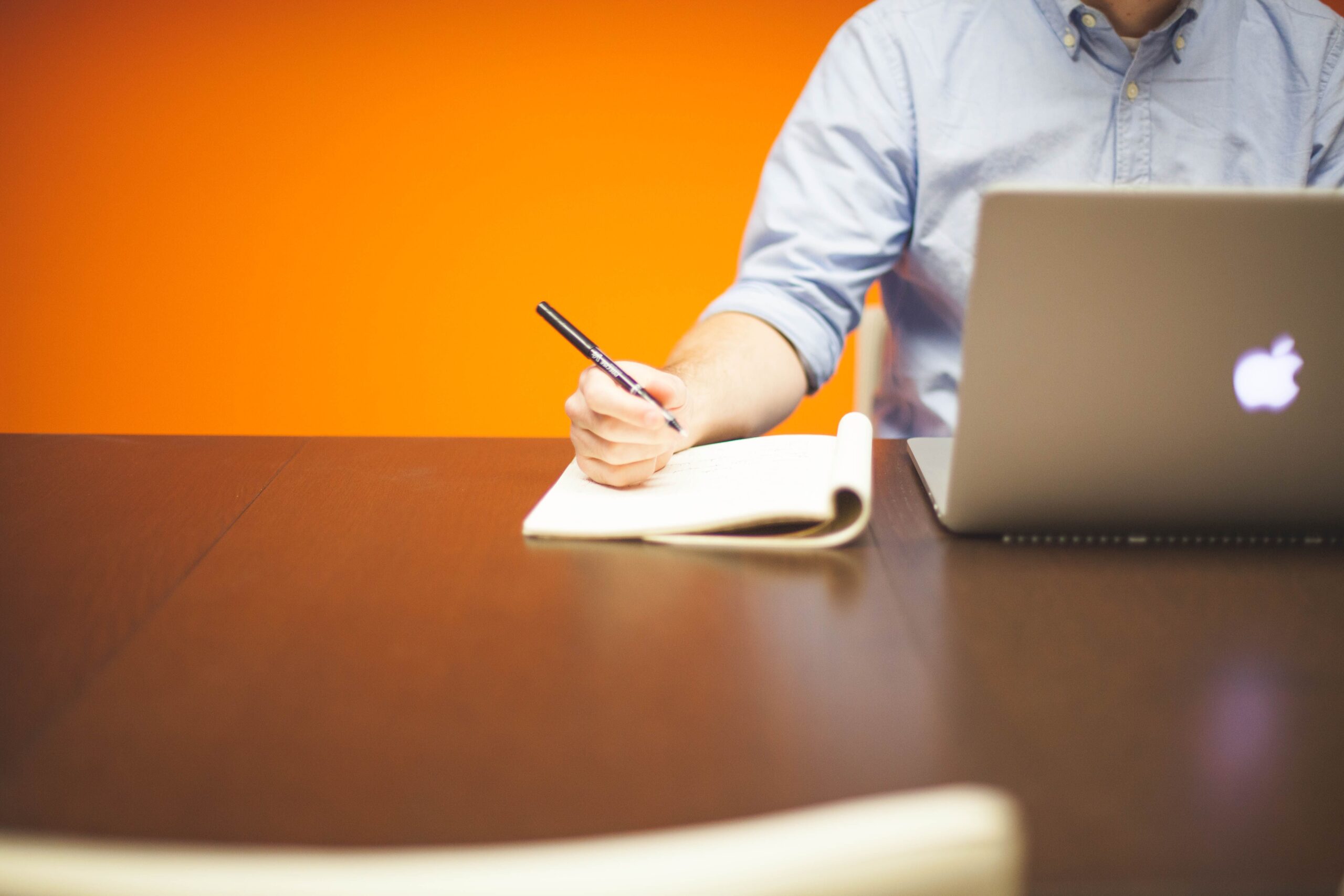 Working professional using a laptop and notebook while attending addiction treatment in Orange County through a flexible outpatient rehab program.
